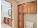 Bathroom featuring vanity with cabinets and mirror, and a toilet with storage at 4215 Edgewood Dr, Holiday, FL 34691