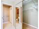 Bathroom featuring mirrored sliding doors and adjacent toilet and walk-in shower at 4215 Edgewood Dr, Holiday, FL 34691