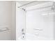 White tiled bathtub with shower head, and safety bar at 4215 Edgewood Dr, Holiday, FL 34691