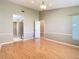 Bright bedroom features wood floors, neutral walls, modern lighting, and walk in closet at 4215 Edgewood Dr, Holiday, FL 34691