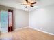 Bedroom with wood floors, ceiling fan, and natural light from window at 4215 Edgewood Dr, Holiday, FL 34691