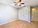 Bedroom features laminate floors, a ceiling fan, and double closet at 4215 Edgewood Dr, Holiday, FL 34691