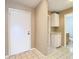 Foyer featuring tile flooring, front door, hallway, and bathroom access at 4215 Edgewood Dr, Holiday, FL 34691