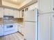 White cabinets and appliances in the kitchen offer a bright and airy atmosphere at 4215 Edgewood Dr, Holiday, FL 34691