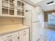 Bright kitchen features white cabinets, countertop, and appliances at 4215 Edgewood Dr, Holiday, FL 34691