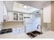 The kitchen has white cabinetry, stainless steel sink and a bright skylight at 4215 Edgewood Dr, Holiday, FL 34691