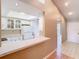 Bright kitchen features white cabinets, a pass-through window, and a skylight for natural light at 4215 Edgewood Dr, Holiday, FL 34691