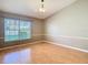 Well-lit room featuring hardwood floors, natural lighting, and neutral walls at 4215 Edgewood Dr, Holiday, FL 34691