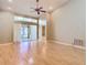 Open living space with high ceilings, hardwood flooring, and sliding doors to outside at 4215 Edgewood Dr, Holiday, FL 34691