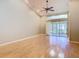 Spacious living room with wood floors, high ceilings, and sliding glass doors at 4215 Edgewood Dr, Holiday, FL 34691