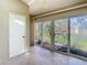 Tiled patio with sliding glass doors leading to the backyard and a door to the interior at 4215 Edgewood Dr, Holiday, FL 34691