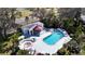 Aerial view of the community pool area with a pool, hot tub, and lounge chairs at 4215 Edgewood Dr, Holiday, FL 34691