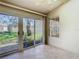 Sunroom with tile floors, ceiling fan, and sliding glass doors to the backyard at 4215 Edgewood Dr, Holiday, FL 34691