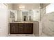 Modern bathroom with a granite countertop, double sink vanity, and a large mirror with a walk-in shower at 5320 Aqua Breeze Dr, Bradenton, FL 34208