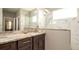 Modern bathroom with a granite countertop, double sink vanity, and a large mirror with a walk-in shower at 5320 Aqua Breeze Dr, Bradenton, FL 34208