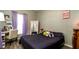 Bedroom with purple curtains, stylish decor, and a comfortable bed, creating a cozy and inviting space at 5320 Aqua Breeze Dr, Bradenton, FL 34208