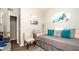 Comfortable bedroom with neutral tones, stylish accents and a cozy chair near an open door at 5320 Aqua Breeze Dr, Bradenton, FL 34208