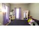 Bedroom with purple curtains, stylish decor, and a comfortable bed, creating a cozy and inviting space at 5320 Aqua Breeze Dr, Bradenton, FL 34208
