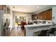 Modern kitchen features a stainless steel refrigerator and view to screened-in lanai at 5320 Aqua Breeze Dr, Bradenton, FL 34208