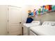 Bright laundry room with efficient washer, dryer, and shelving for storage and organization at 5320 Aqua Breeze Dr, Bradenton, FL 34208
