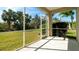 Enjoy serene views from this screened-in patio overlooking lush backyard landscaping with green grass at 5320 Aqua Breeze Dr, Bradenton, FL 34208