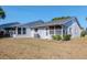 Backyard with a well-maintained lawn and the exterior of the house with an enclosed sun room at 7710 Danube Dr # A, Hudson, FL 34667
