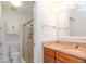 Bathroom with a tiled shower, granite countertop, and a vanity with wood drawers and doors at 7710 Danube Dr # A, Hudson, FL 34667