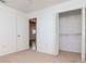Bedroom with open closet space and a connecting hall, featuring neutral walls and carpet at 7710 Danube Dr # A, Hudson, FL 34667
