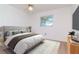 Bedroom with a ceiling fan and a plush bed with a large window providing natural light at 7710 Danube Dr # A, Hudson, FL 34667