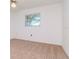 Bedroom with neutral carpet, white walls, and a ceiling fan, offering a blank canvas at 7710 Danube Dr # A, Hudson, FL 34667