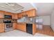 Spacious kitchen showcasing stainless steel appliances, granite countertops, and views of adjacent rooms at 7710 Danube Dr # A, Hudson, FL 34667