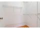 Walk-in closet with laminate flooring and adjustable white wire shelving on all sides at 7710 Danube Dr # A, Hudson, FL 34667