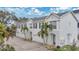 Charming townhome featuring a crisp white exterior, a private garage, and lush tropical landscaping at 2607 W Cleveland St # B, Tampa, FL 33609