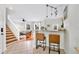 Open-concept living space with bar seating, stairs, and view into a cozy living room with lots of natural light at 2607 W Cleveland St # B, Tampa, FL 33609