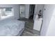 Cozy bedroom featuring grey hardwood floors, a comfortable bed, and a view of the outside at 3818 Moog Rd, Holiday, FL 34691