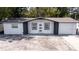 Charming single-story home featuring a new paint job, an attached one-car garage, and a spacious front yard at 3818 Moog Rd, Holiday, FL 34691