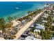 Stunning aerial view of beachside homes with pristine blue ocean waters and lush tropical landscaping at 415 N Bay Blvd, Anna Maria, FL 34216