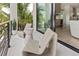 Private balcony with seating area and a view of the tropical landscaping at 415 N Bay Blvd, Anna Maria, FL 34216