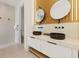 Modern bathroom with a double sink vanity, round mirrors, and sleek fixtures at 415 N Bay Blvd, Anna Maria, FL 34216