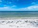 Scenic view of a serene beach with clear water, white sand, and a vibrant blue sky at 415 N Bay Blvd, Anna Maria, FL 34216