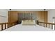 Bright bedroom featuring a padded headboard, bedside lights, and soft textures at 415 N Bay Blvd, Anna Maria, FL 34216