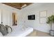 This bedroom features a ceiling fan, a wall-mounted TV, and artwork for a cozy retreat at 415 N Bay Blvd, Anna Maria, FL 34216