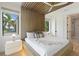 Modern bedroom showcasing a wood slat ceiling, complemented by large windows for ample daylight at 415 N Bay Blvd, Anna Maria, FL 34216