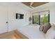 Bright bedroom featuring a ceiling fan and a large window providing plenty of natural light at 415 N Bay Blvd, Anna Maria, FL 34216