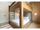 Fun bedroom with wooden bunk beds, wood paneling, and modern lighting at 415 N Bay Blvd, Anna Maria, FL 34216