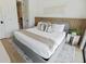 Comfortable bedroom with a plush bed, modern decor, and convenient access to the bathroom at 415 N Bay Blvd, Anna Maria, FL 34216