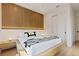 Modern bedroom with a wood accent wall, minimalist decor, and stylish side tables at 415 N Bay Blvd, Anna Maria, FL 34216