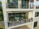 Multi-story home featuring balconies with seating and large windows at 415 N Bay Blvd, Anna Maria, FL 34216