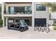 Modern two-story home with a golf cart, three bicycles, and a garage at 415 N Bay Blvd, Anna Maria, FL 34216