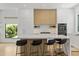 Sleek modern kitchen featuring a center island with bar seating and contemporary cabinetry with white countertops at 415 N Bay Blvd, Anna Maria, FL 34216